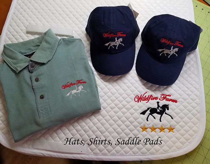 A pair of hats and polo shirts on top of a mattress.