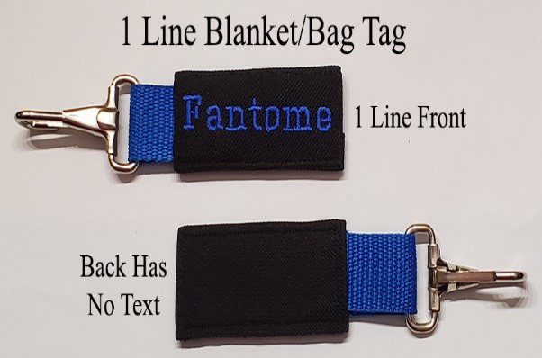 A black and blue tag with the name of a person on it.
