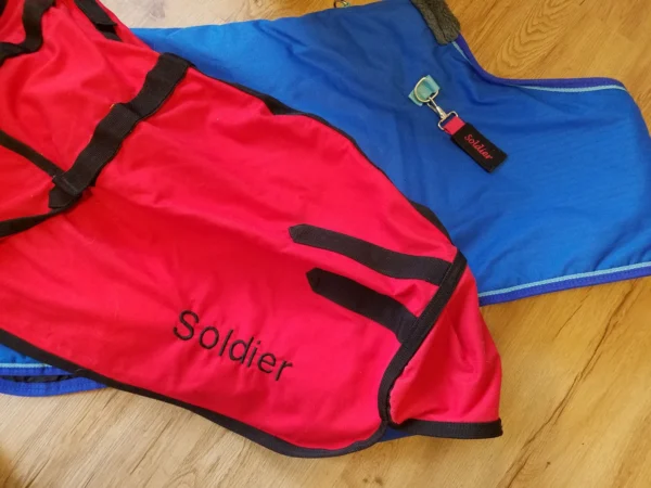 A pair of bags on the floor with the word soldier written in them.