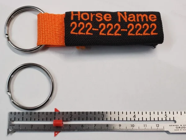 A key chain with the name of a horse and a ruler.
