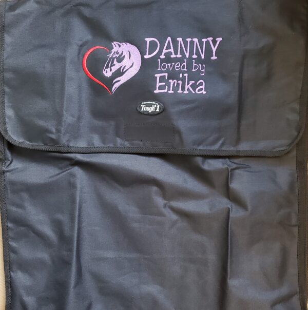A black bag with the name of danny and a heart.