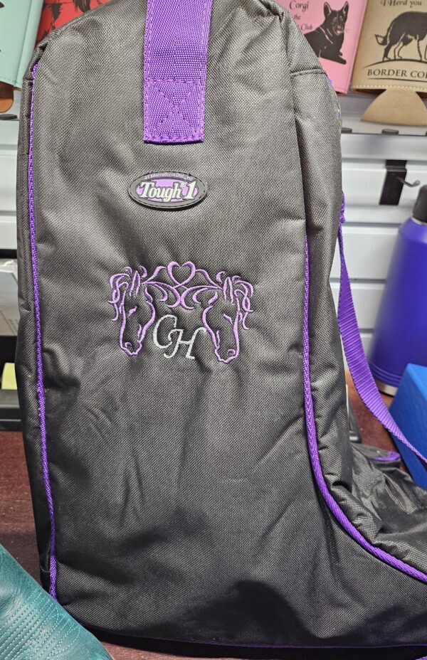 A black bag with purple trim and an elephant on it.